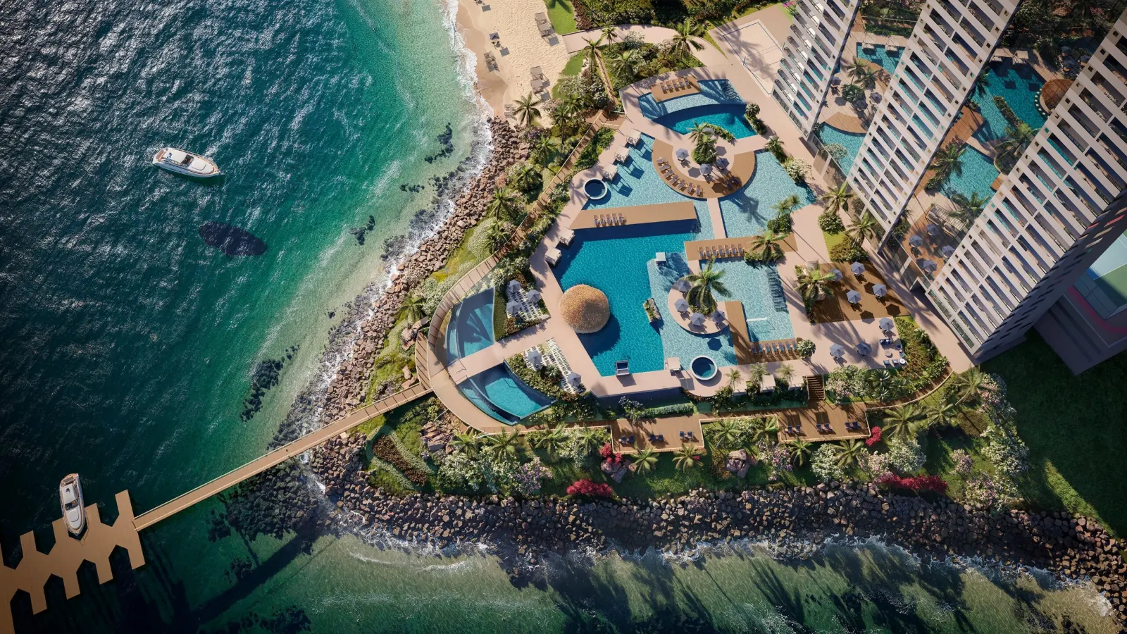 Vista aérea da praia privativa, piscinas e pier